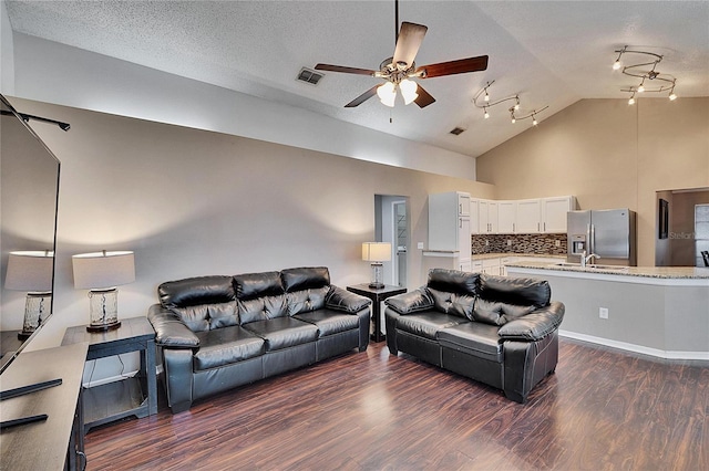 living room featuring high vaulted ceiling, sink, ceiling fan, dark wood-type flooring, and a textured ceiling