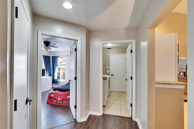 hall featuring hardwood / wood-style flooring and independent washer and dryer