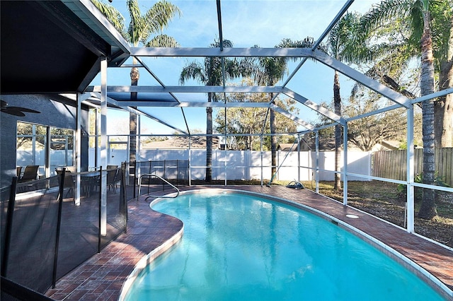 view of pool with a patio and glass enclosure