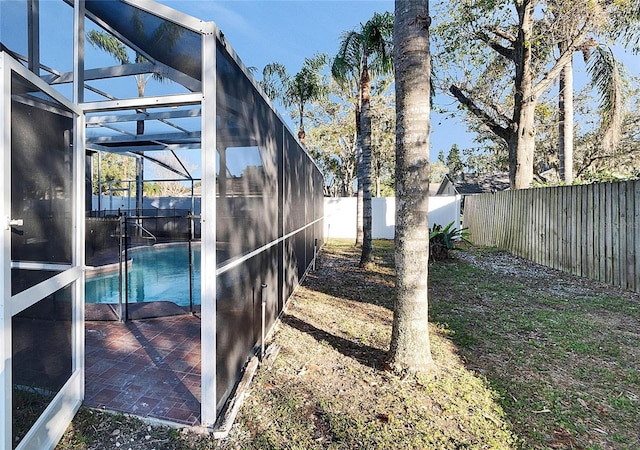 view of yard with a fenced in pool and a lanai