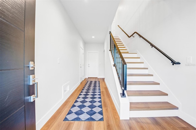 stairs with hardwood / wood-style floors