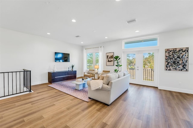 living room with light hardwood / wood-style flooring and french doors