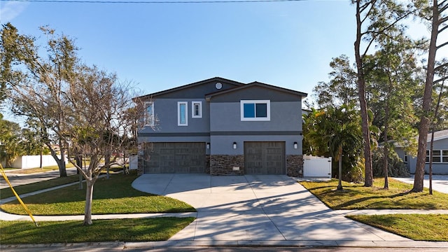 view of property featuring a garage and a front yard