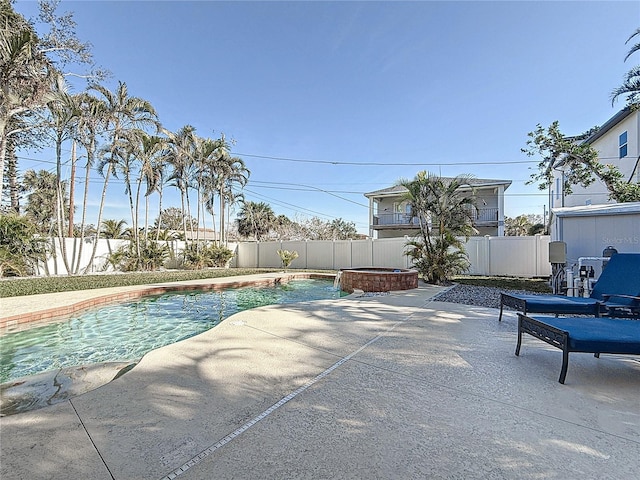 view of pool featuring a patio and an in ground hot tub