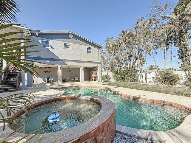 view of swimming pool with a patio, ceiling fan, and an in ground hot tub