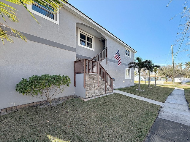 view of side of home with a lawn