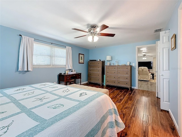 bedroom with ceiling fan and dark hardwood / wood-style flooring