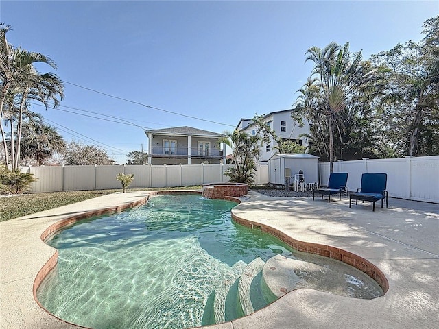 view of swimming pool featuring a patio area and a storage unit