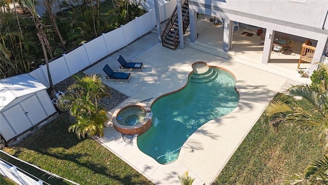 view of pool featuring a patio area and an in ground hot tub