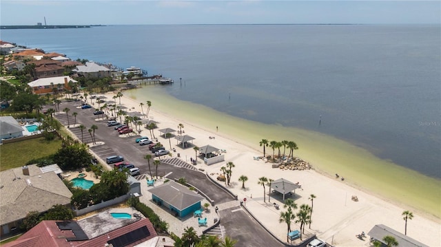 bird's eye view featuring a water view and a beach view