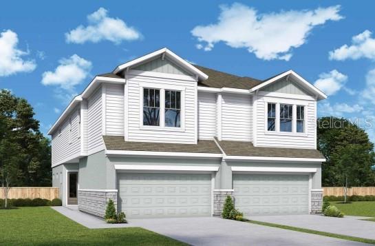 view of front of home featuring an attached garage, fence, concrete driveway, stone siding, and a front yard