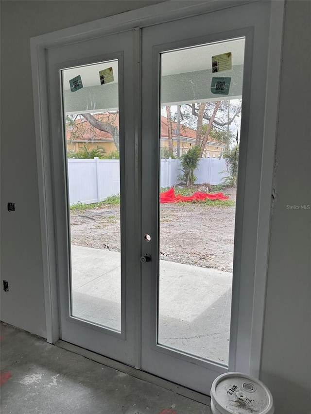 doorway to outside with french doors and concrete floors