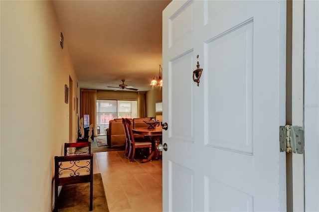 hall with light tile patterned floors