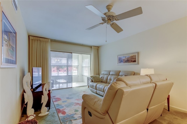 living room featuring light carpet and ceiling fan