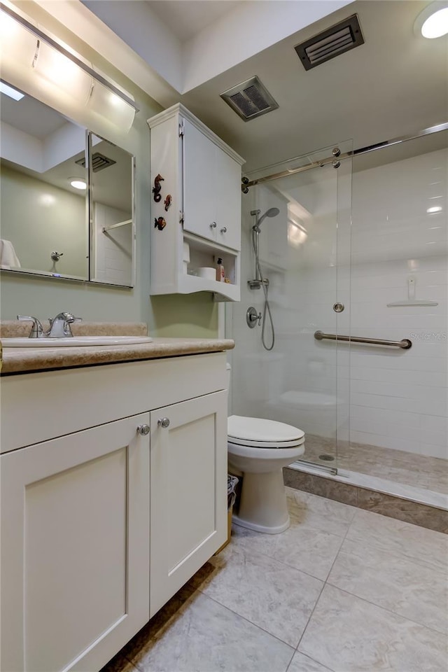 bathroom with vanity, a shower with shower door, and toilet