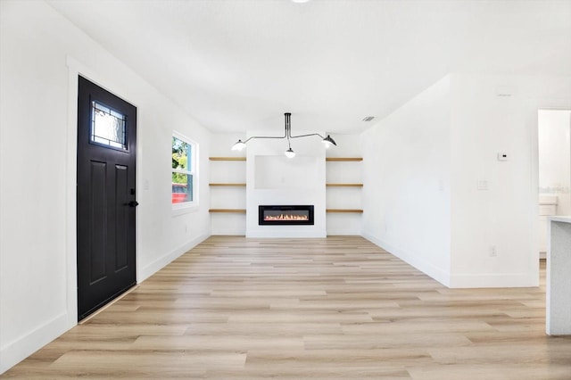 unfurnished living room featuring light hardwood / wood-style floors