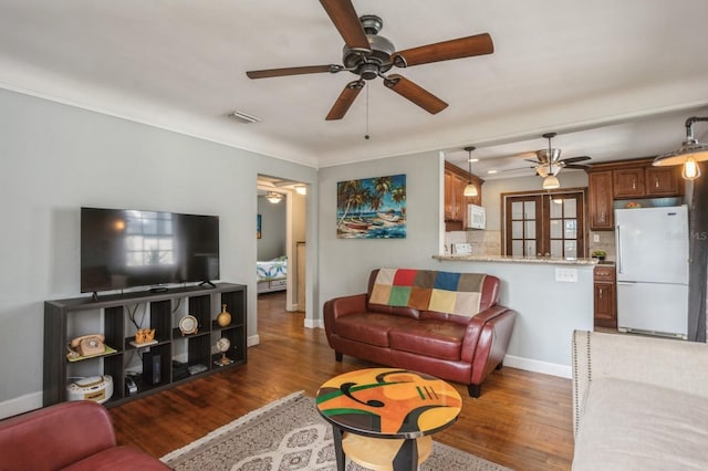 living room featuring dark hardwood / wood-style flooring and ceiling fan