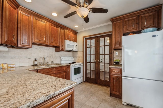 kitchen with sink, decorative backsplash, crown molding, white appliances, and french doors