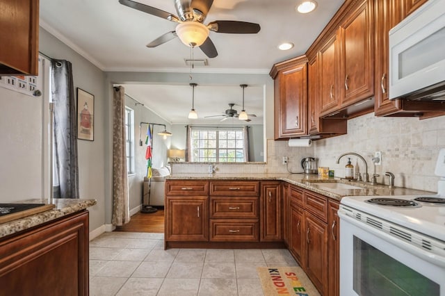 kitchen featuring sink, decorative light fixtures, ornamental molding, white appliances, and decorative backsplash