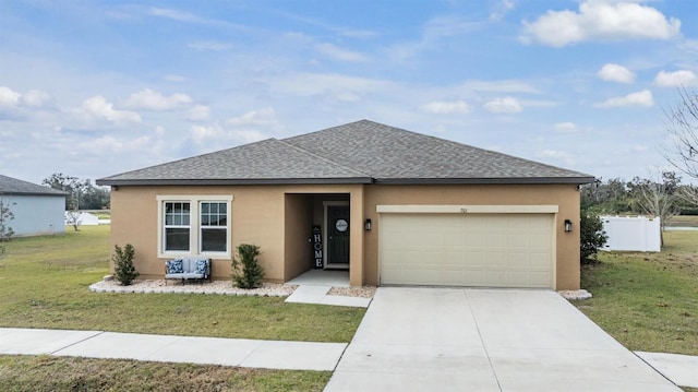 view of front facade featuring a garage and a front yard