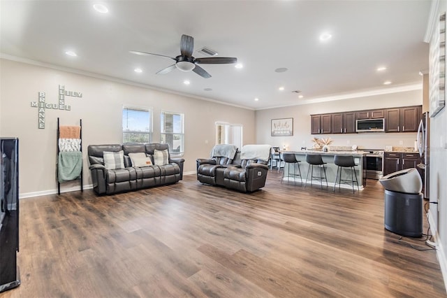 living room featuring crown molding, ceiling fan, and hardwood / wood-style floors