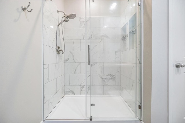 bathroom with a shower with shower door