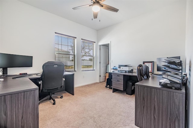 carpeted office featuring ceiling fan