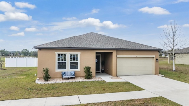 view of front of property featuring a garage and a front yard