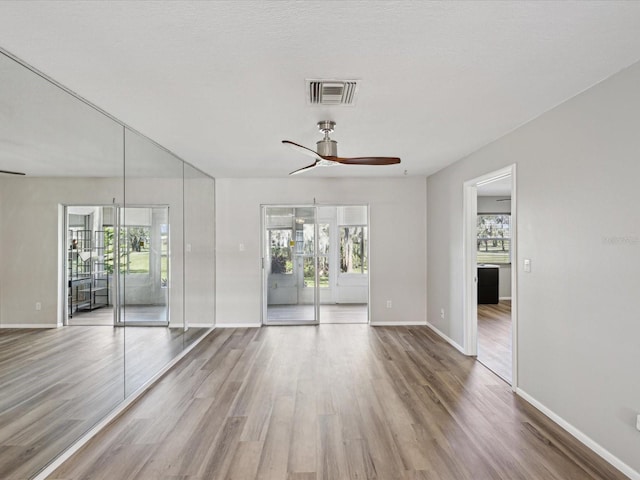 unfurnished room featuring ceiling fan and wood-type flooring