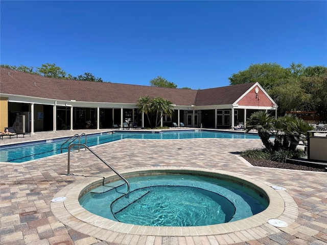 view of swimming pool featuring a community hot tub