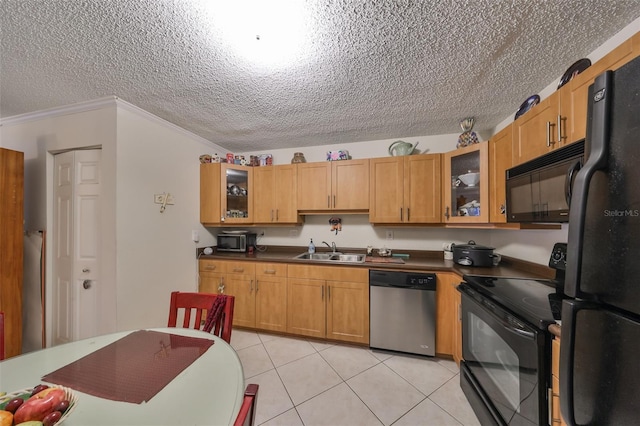 kitchen featuring sink, ornamental molding, light tile patterned floors, black appliances, and a textured ceiling