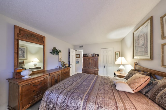 bedroom with a closet and a textured ceiling