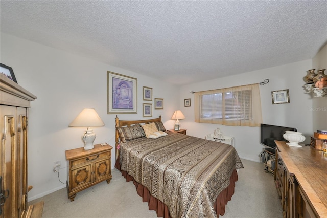 bedroom featuring light colored carpet and a textured ceiling