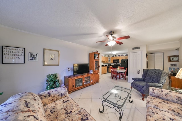 tiled living room featuring ceiling fan and a textured ceiling