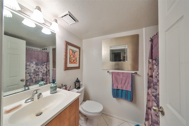 bathroom with vanity, tile patterned floors, a textured ceiling, and toilet