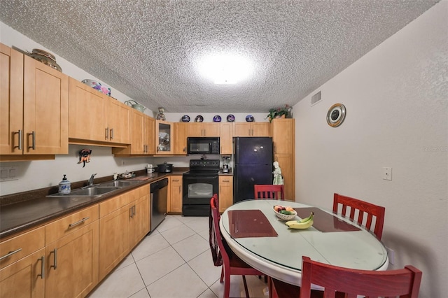 5557 Baywater Dr, Tampa, FL 33615 - kitchen featuring light tile patterned floors, visible vents, dark countertops, glass insert cabinets, and black appliances