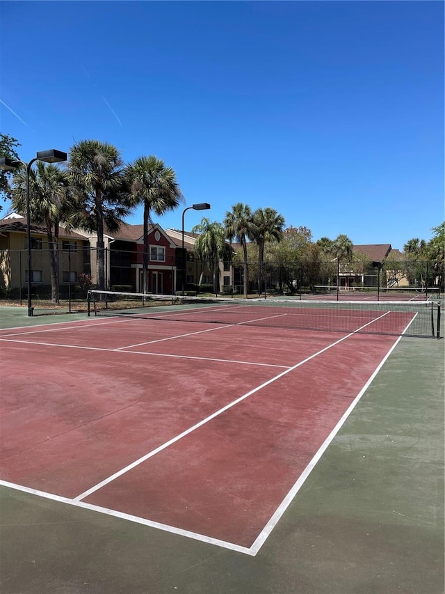 5557 Baywater Dr, Tampa, FL 33615 - view of tennis court with community basketball court and fence