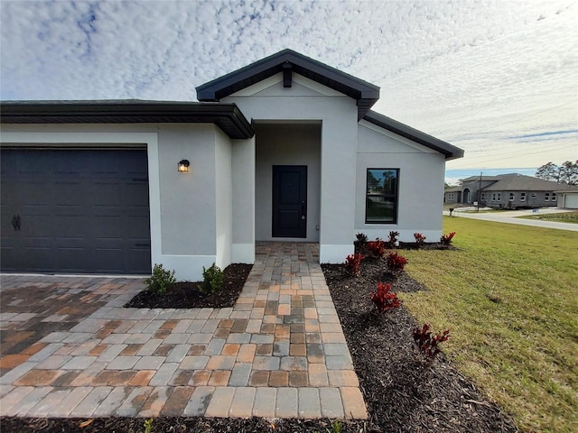 view of front of house with a garage and a front yard