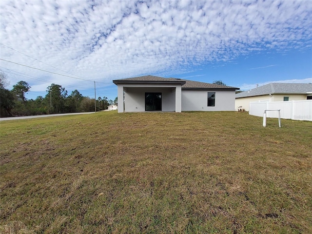 back of property featuring a yard