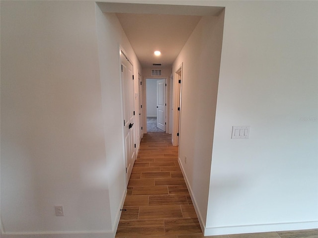 corridor featuring dark hardwood / wood-style flooring