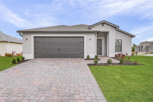5710 Humkey St, North Port, FL 34291 - view of front of house featuring a front yard, decorative driveway, stucco siding, and an attached garage
