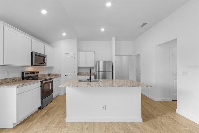 5710 Humkey St, North Port, FL 34291 - kitchen with a sink, appliances with stainless steel finishes, a kitchen island with sink, white cabinets, and light wood-style floors