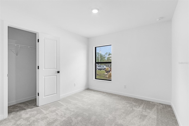 5710 Humkey St, North Port, FL 34291 - unfurnished bedroom with carpet floors, a walk in closet, baseboards, and a closet