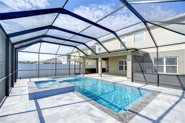 view of pool featuring an in ground hot tub, a lanai, and a patio