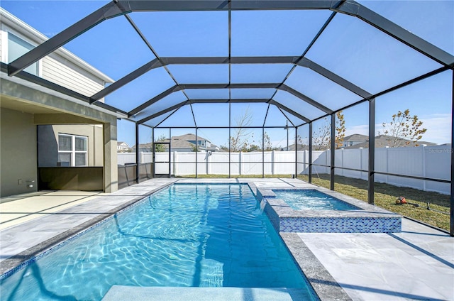 view of pool with an in ground hot tub, a lanai, and a patio