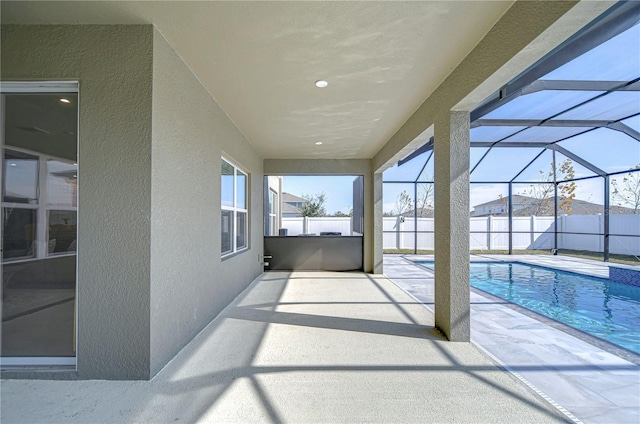 view of patio / terrace with a fenced in pool and glass enclosure