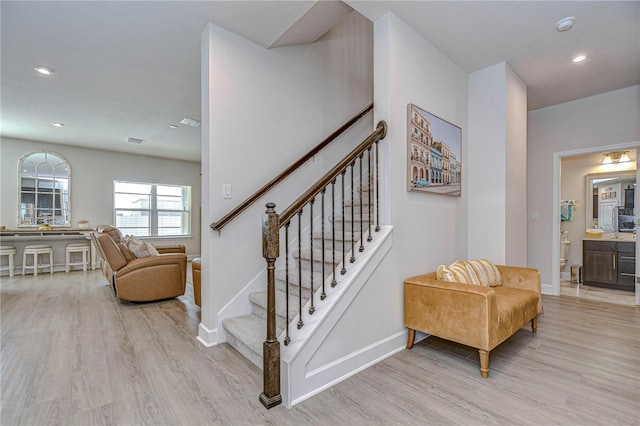 staircase with hardwood / wood-style floors