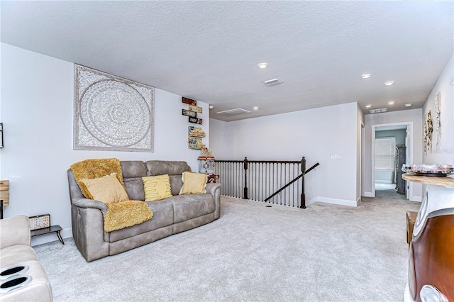 carpeted living room with a textured ceiling