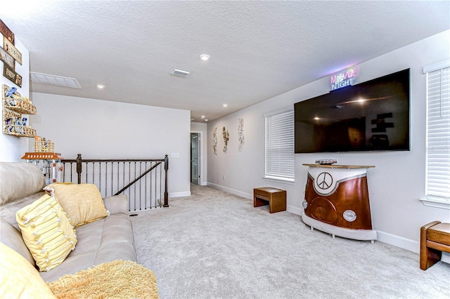 living room with light colored carpet and a textured ceiling