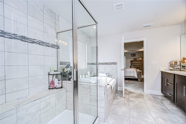 bathroom with independent shower and bath, vanity, and tile patterned floors